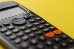 A calculator in a yellow background